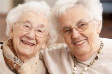 Two elderly ladies smiling